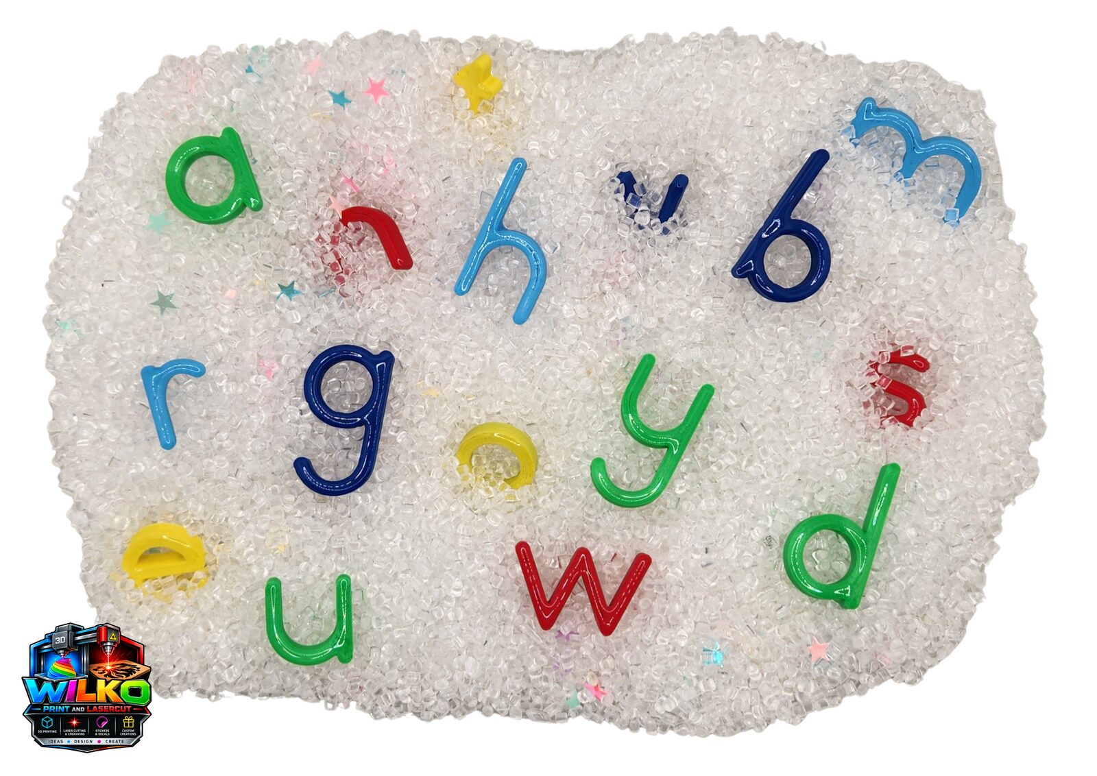 Colourful 3D printed letters a, h, n, b, r, g, o, y, s, u, w, d hidden in a sensory bin